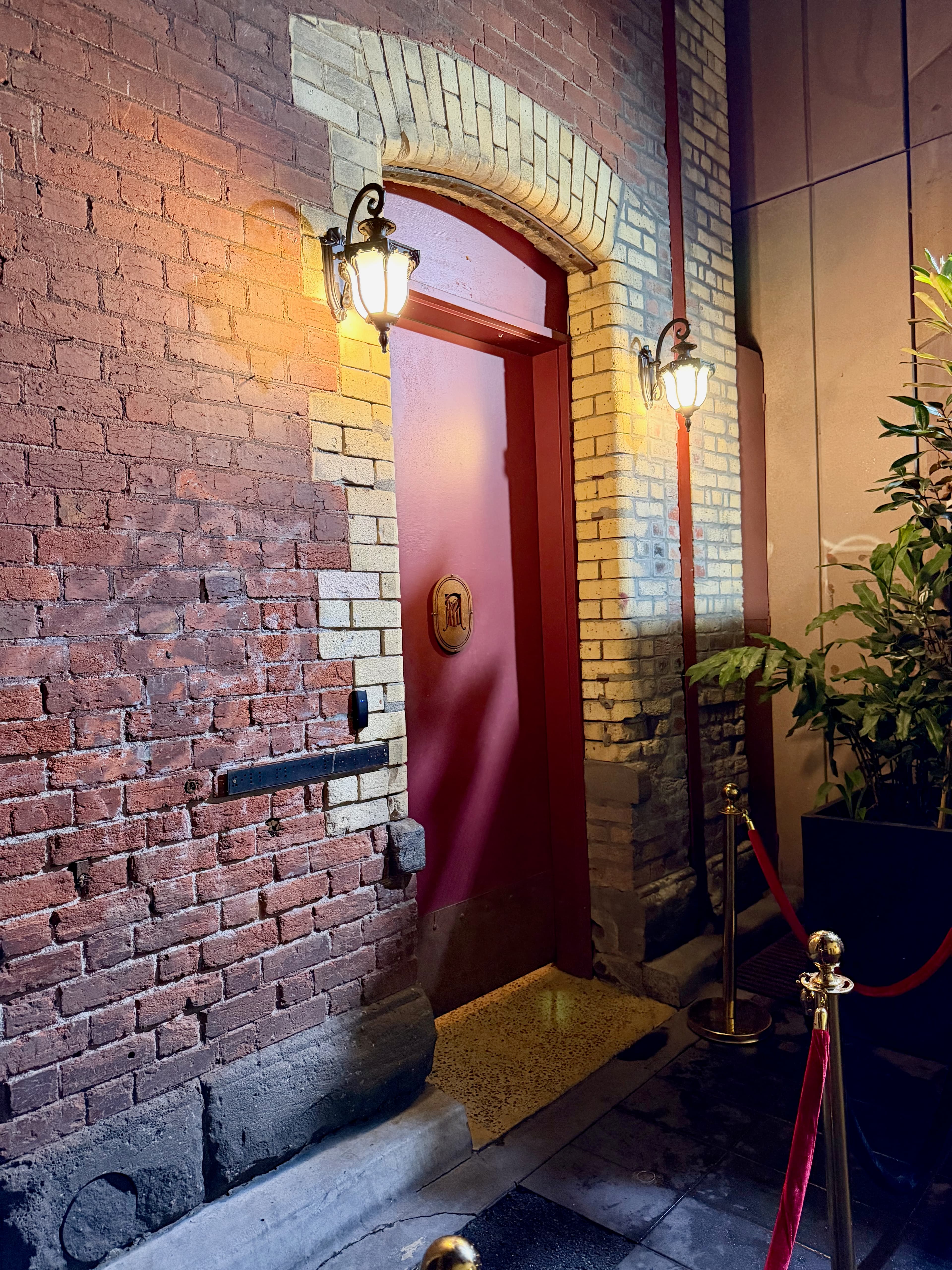 Red door entrance to Mjølner bar in a Melbourne alley